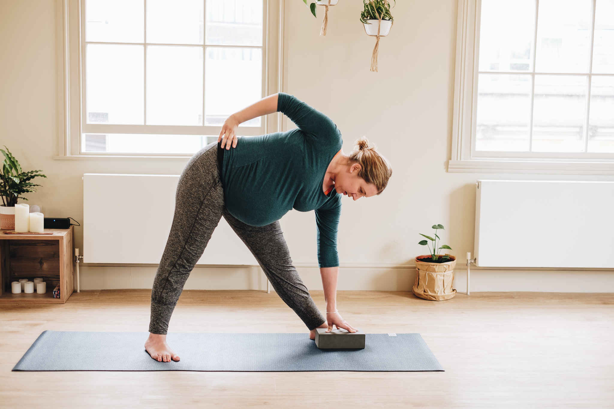 Pregnant yoga teacher in triangle pose